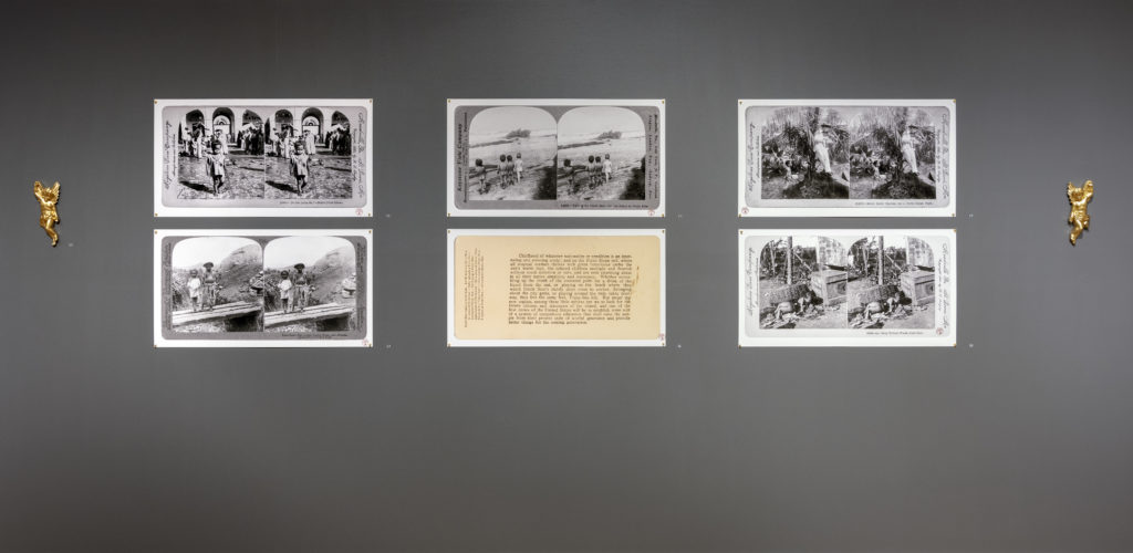 Installation detail showing reproduced stereograph cards, The Museum of the Old Colony: An Art Bottom row center image depicts the verso of the stereograph card Waiting for Uncle Sam – On Installation by Pablo Delano, Duke Galley of Fine Arts, James Madison University, Harrisonburg, VA, 2022. the Beach at Porto Rico, seen above it. Pigment prints on rag paper, each is 36” wide. photo: Pablo Delano
